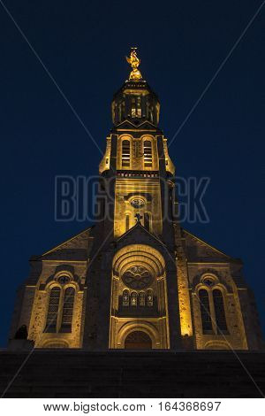 Church of Saint Michael in Saint-Michel-Mont-Mercure France with a large figure of the Archangel Michael at the top of the tower