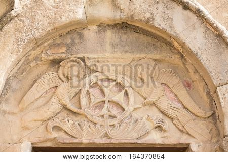 Mtskheta, Georgia. Close View Of Bas-Relief Glorification Of The Cross Crowning The Entrance To The Ancient Jvari Monastery, Georgian Orthodox Church Of Holly Cross, World Heritage By Unesco.