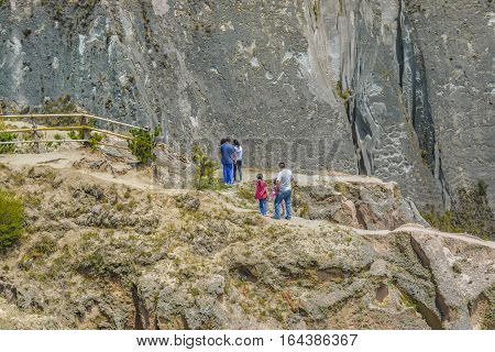LATACUNGA, ECUADOR, FEBRAURY - 2016 - Group of people crossing a path at rocky mountains in Latacunga district Ecuador South America