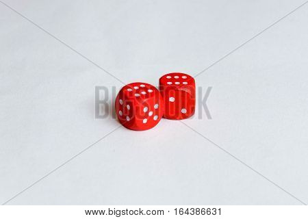Two red isolated dice showing six pips each.