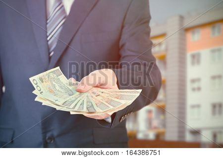 Polish Businessman Holds Money. The Loan On The House