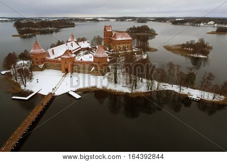 Trakai, Lithuania: aerial winter UAV top view, flat lay of gothic Island Castle. Historical residence in capital city of Grand Duchy of Lithuania, located in Galve lake