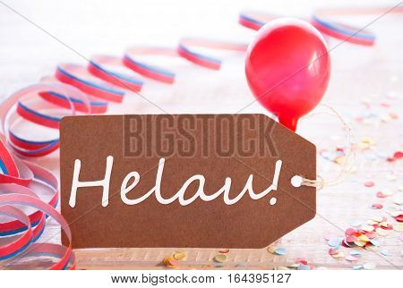 One Label With German Text Helau Means Happy Carnival. Party Decoration Like Streamer, Confetti And Balloon. Wooden Background With Vintage, Retro Or Rustic Syle