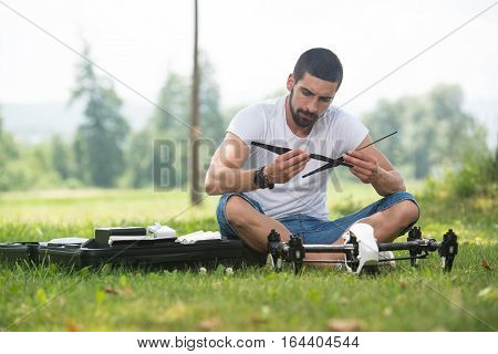 Man Tightening Propeller On Drone In Nature