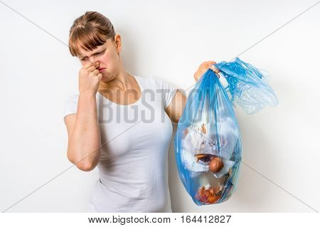 Woman Holding A Smelly Garbage Bag