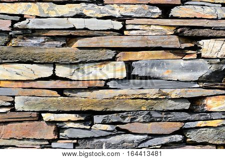 Schist stones on a house piled to a wall
