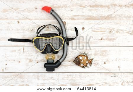 Scuba diving and snorkelling. Diving mask and snorkel on wood background