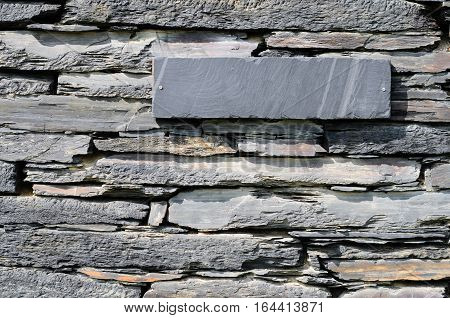 Schist stones on a house piled to a wall