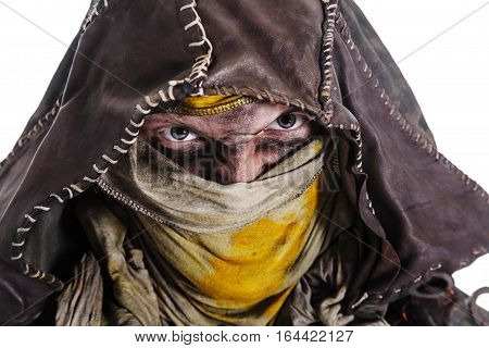 Nuclear post apocalypse life after doomsday concept. Scary closed face of grimy survivor in tatters. Studio closeup portrait white background