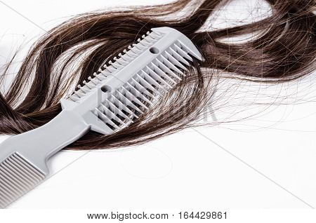 Comb slice hair with blade and hairs on white background.