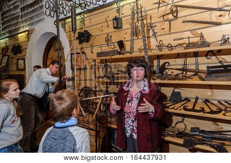 Kolomna, Russia - January 03 2017: Guide of private museum Blacksmith Settlement on the background of the exhibits by Andrey Kopylov, aka linkpusher
