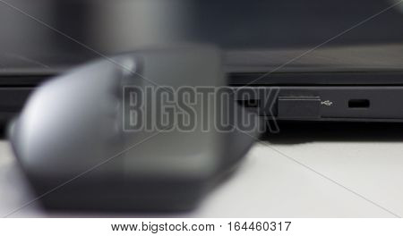 Wireless mouse connected to laptop via mini usb dongle.
