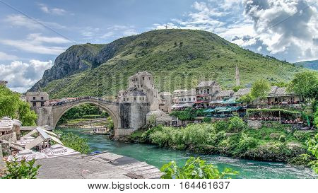 Mostar, Bosnia Herzegovina - May 1, 2014: Stari Most bridge and the cross on the hill in Mostar