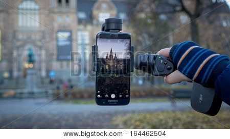 Stockholm, Sweden - October 28, 2016: DJI Osmo Mobile gimbal device with Android Samsung phone