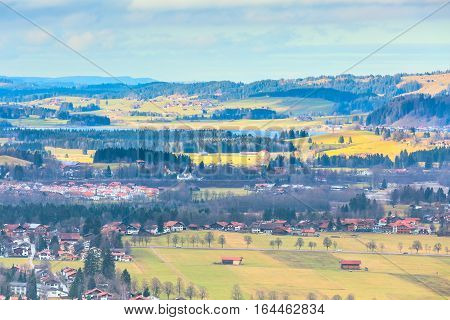 Bavaria landsape aerial view with traditional bavarian village houses and lake in Germany