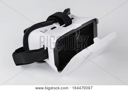 Virtual reality VR glasses or goggles isolated on white background with mirror reflection. Closeup product photograph. Computer simulated reality concept image with copy space 3D