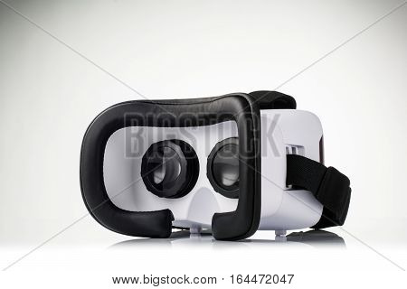 Virtual reality VR glasses or goggles isolated on white background with mirror reflection. Closeup product photograph. Computer simulated reality concept image with copy space 3D