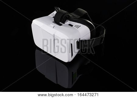 Virtual reality VR glasses or goggles isolated on black background with mirror reflection. Closeup product photograph. Computer simulated reality concept image with copy space 3D