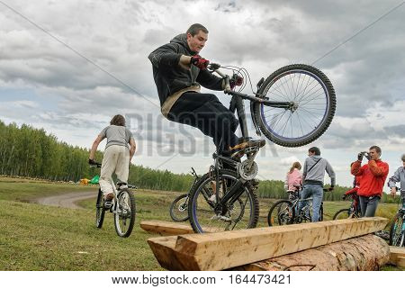 Tyumen, Russia - September 16, 2007: Second festival of cyclists Samogon. Cyclists perprygivat through a log as a sports stage