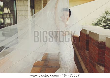 Wind hides bide's face behind a veil