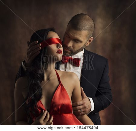 Sexy Couple Love Kiss Man in Suit Kissing Sensual Woman Red Fashion Blindfold on Girl Eyes
