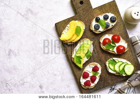 Assortment Of Fruit And Vegetable Toasts With Ricotta.top View.