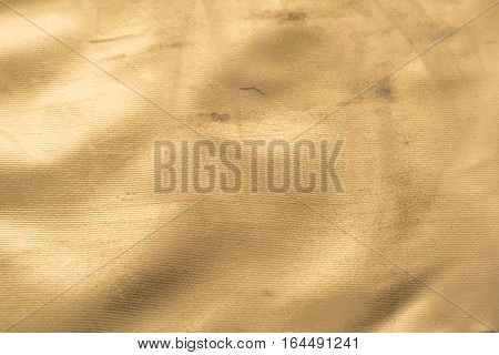 Gold texture with kinks and scratches abstract background. Golden background