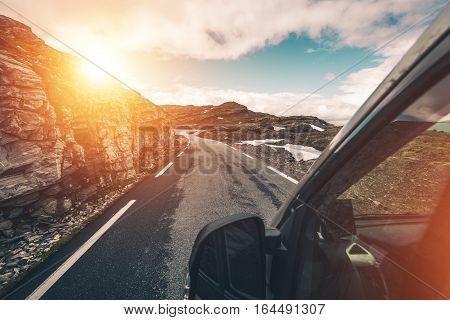 Wilderness Camper Travel. Driving Motorhome Through Mountain Wilderness Landscape. RVing and Camping Photo Concept.