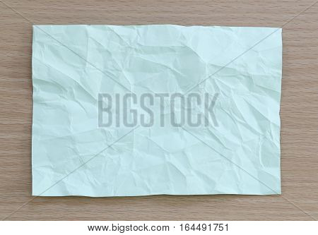 Green notepad paper wrinkled of empty and copy space on wooden backgroundYou can input the message text in picture.