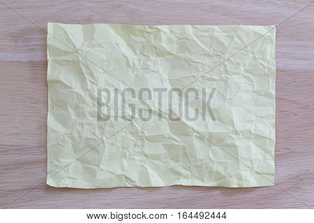 Yellow notepad paper crumpled of empty and copy space on wooden backgroundYou can input the message text in picture.