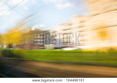 Blurred photograph of a cityscape from a train in movement