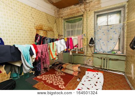 Sleeping area for refugee and refugees' clothes is drying of on the rope in the temporary apartment