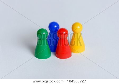 Four pawns with different color each in a group.