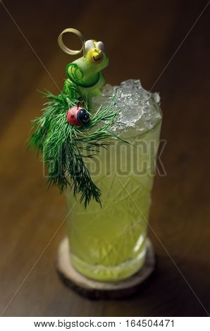 Cold cocktail with cucumber and parsley decorated with bee and ladybug