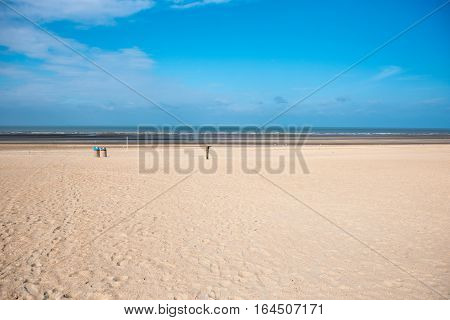 Beach of the North Sea in Koksijde Belgium under blue sky