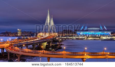 Saint-Petersburg Russia - December 28 2016: Winter cityscape to the football stadium to the World Cup in 2018 cable-stayed bridge and highway at night.
