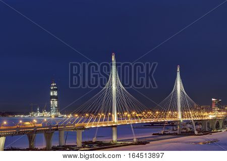 Saint-Petersburg Russia - January 3 2017: Night view of the headquarters of Gazprom through the pylons of the cable-stayed bridge of the Western High Speed Diameter in St. Petersburg.