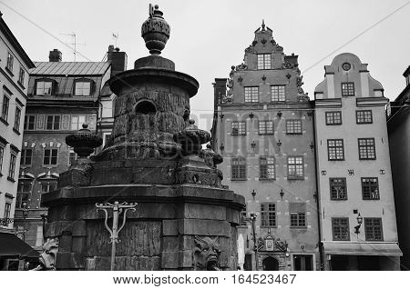Statue with water outlets at Stortorget Stockholm Sweden in black and white photography