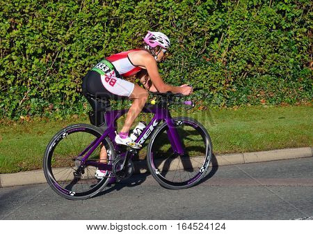 ST NEOTS, CAMBRIDGESHIRE, ENGLAND - SEPTEMBER 11, 2016: Triathlon competitor on road cycling stage of competition.