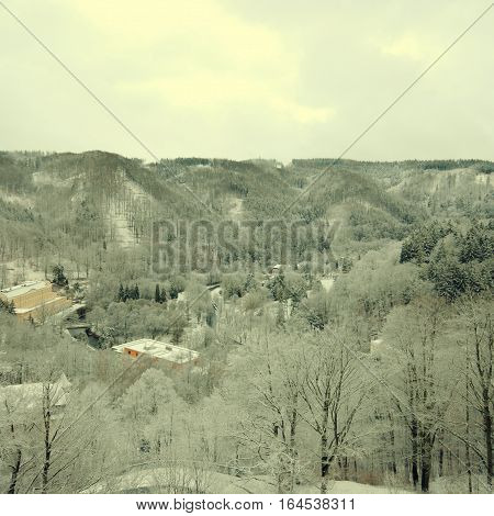 Magic view of a snow-covered forest hills, Chezh Republic. Square toned image