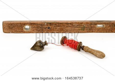 Old level tool and plummet isolated on white background
