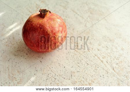 red pomergranate at stone surface texture background