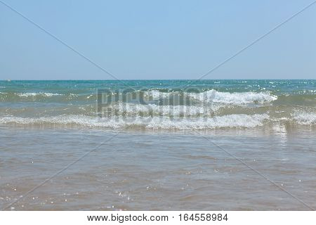 Sea blue bottom summer wave background. Vacation relax on the beach. The beautiful sandy beach of the Mediterranean Sea.