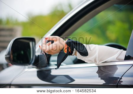 Car Keys. Seller woman hand giving keys