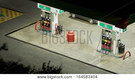 Gas station pump at night light tme