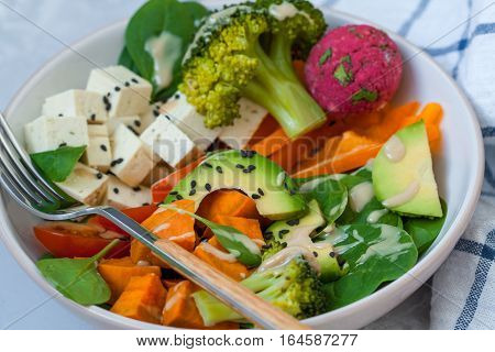 Green vegan salad with broccoli beetroot and sweet potato falafel.