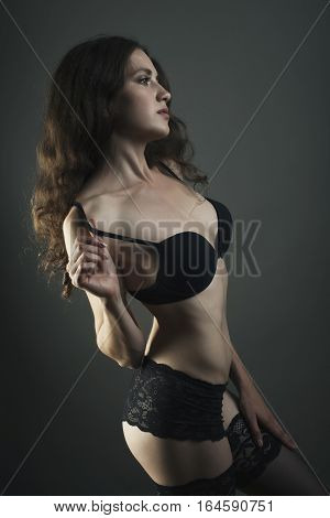Sexy Young Woman Body In Black Lingerie On Dark Background.
