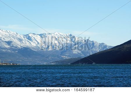 The winter sea and the snow-covered slopes
