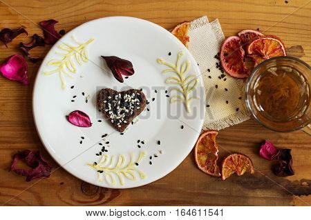 Herbal tea and homemade candy. Vegan sweets. Dry decorative oranges and flowers. Food background.