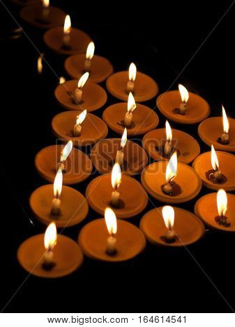 COLOR PHOTO OF OFFERING LIT CANDLES IN HARMONY